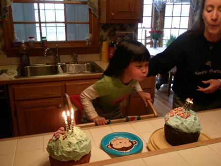 Kasen blowing out candles on Boy cake